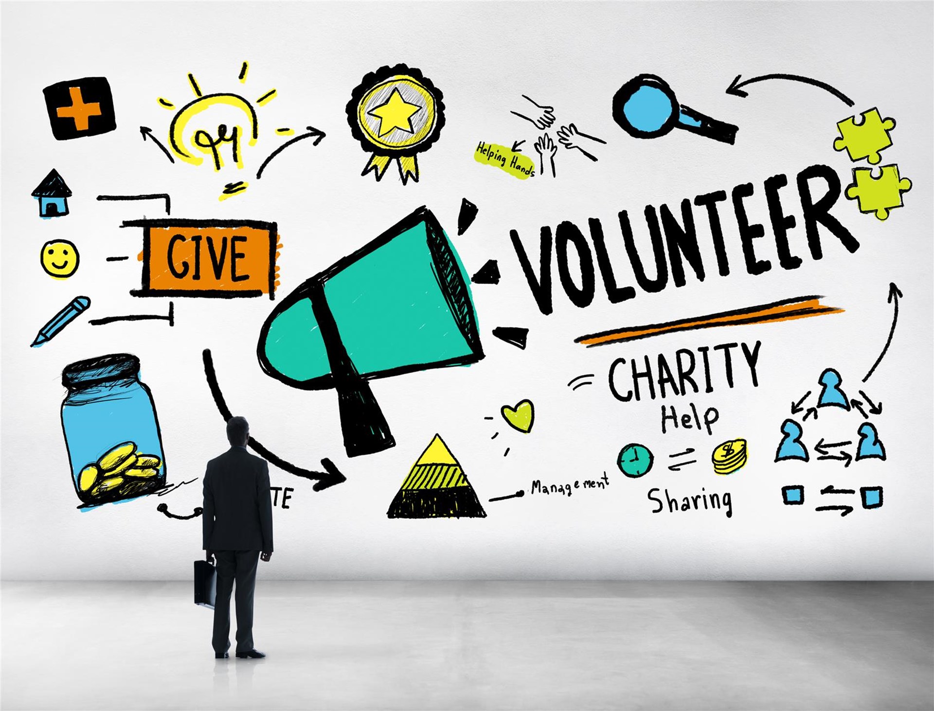 Illustration einer Wand mit bunten Grafiken zu Freiwilligenarbeit, Spenden und Charity. Ein Mann in Anzug steht davor und betrachtet die Zeichnungen.